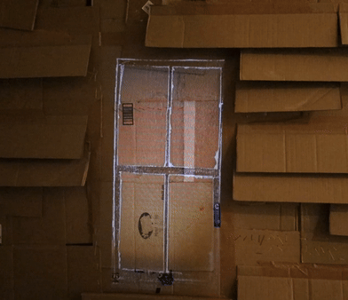 A video projected on a cardboard structure